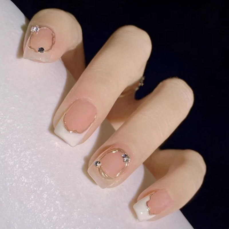 Close-up of a hand with decorative nails on a white background