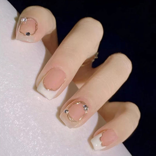 Close-up of a hand with decorative nails on a white background
