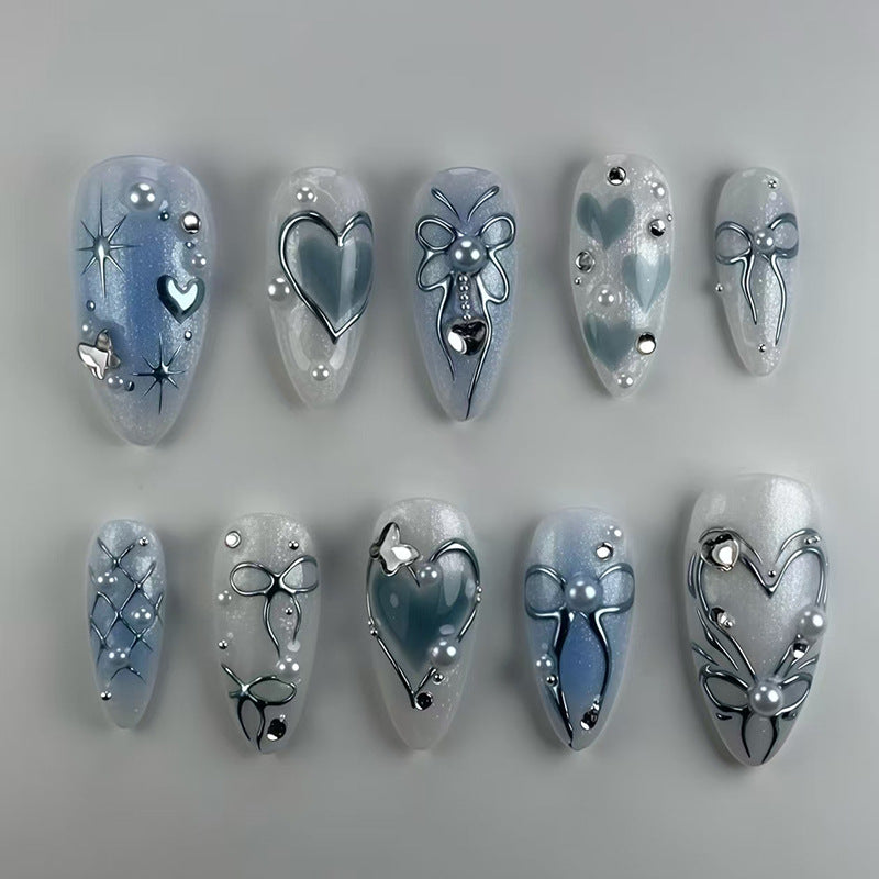 Decorative nail art with blue and silver designs on a gray background
