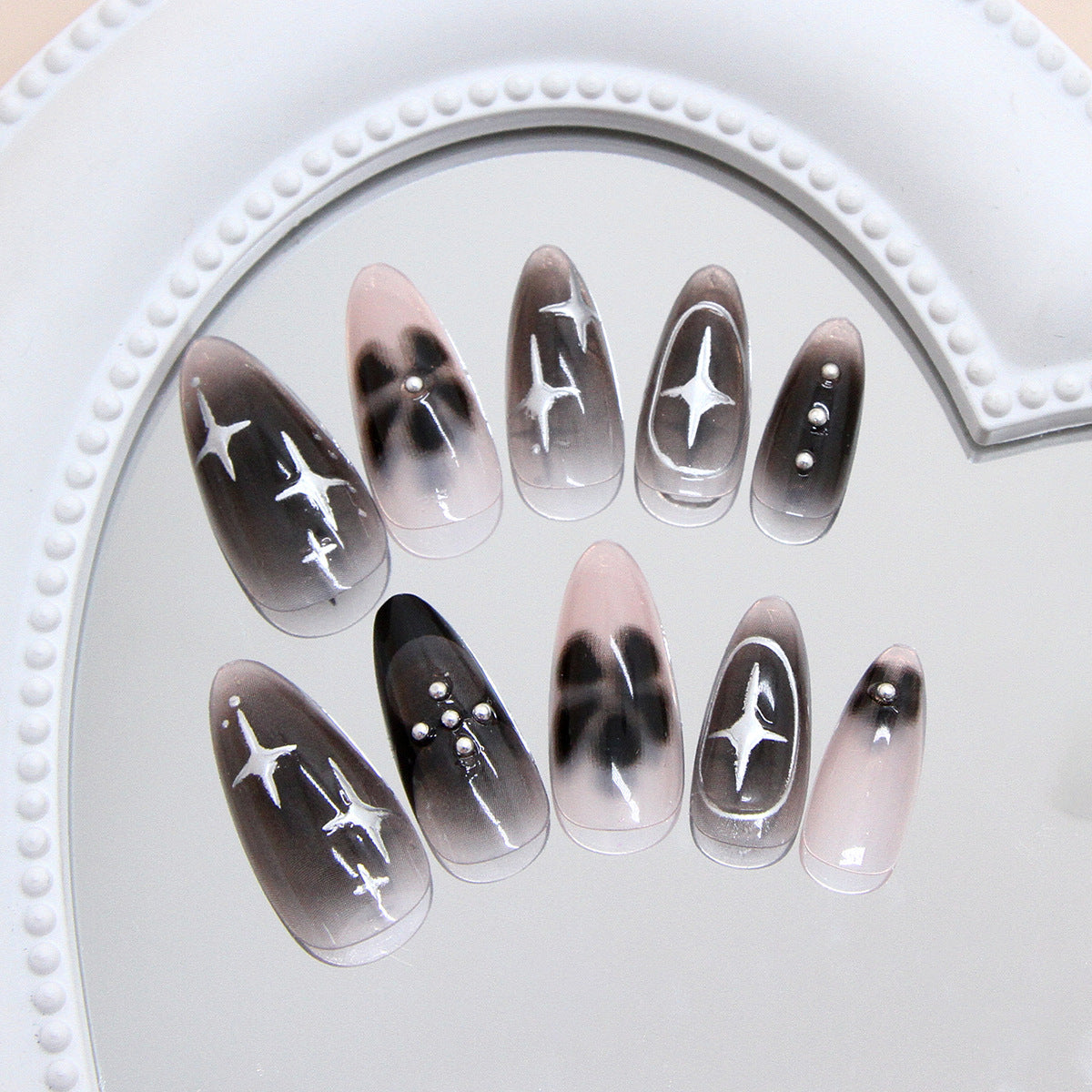 Celestial Dreamland Medium Almond Ombre Black and Pink Nail Set with Starry Accents