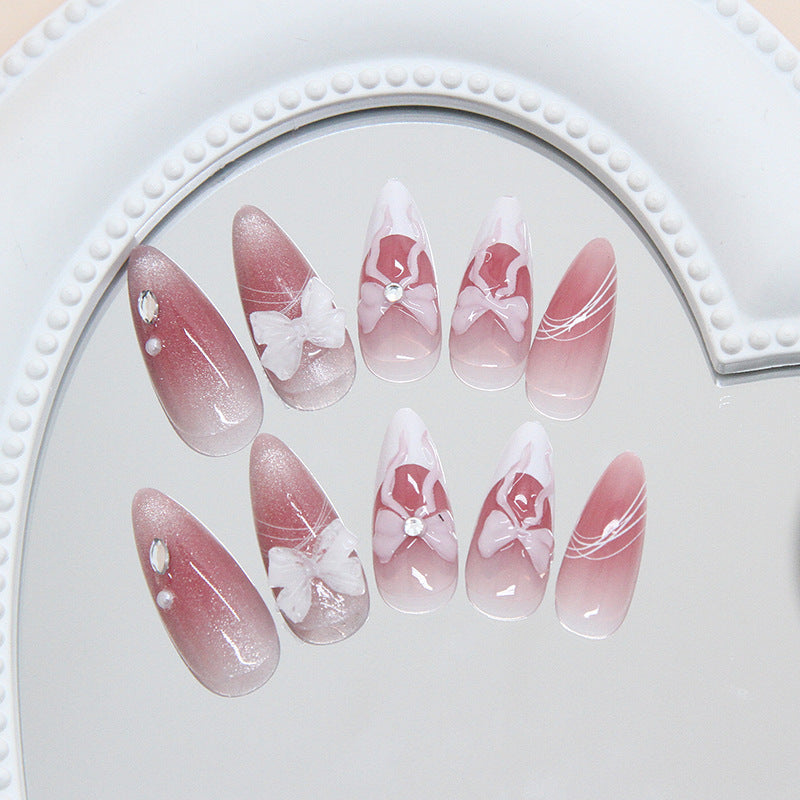 Whimsical Elegance Long Almond Pink Ombre Nail Set with Charming Bow and Jewel Accents