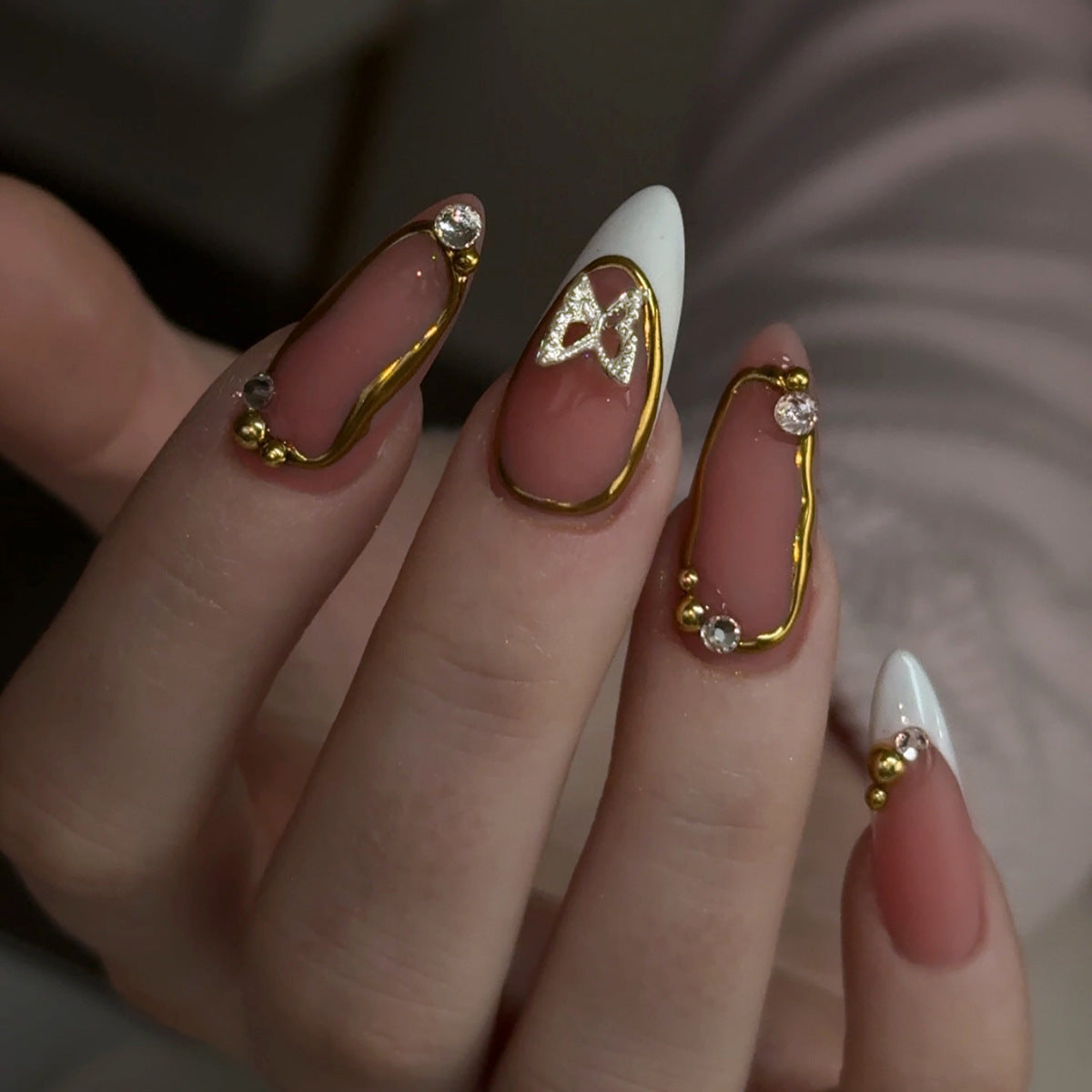 Enchanting Elegance Long Almond Blush Pink and White Nail Set with Glittering Gold Accents and Crystal Embellishments