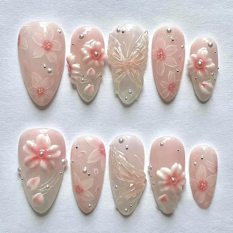 Blossom Elegance Charming Long Almond Shaped Soft Pink Press On Nail Set Featuring Intricate Floral Designs and Butterfly Accents