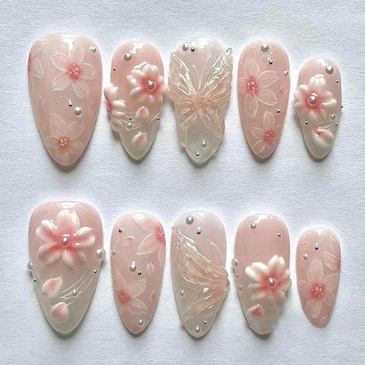 Blossom Elegance Charming Long Almond Shaped Soft Pink Press On Nail Set Featuring Intricate Floral Designs and Butterfly Accents