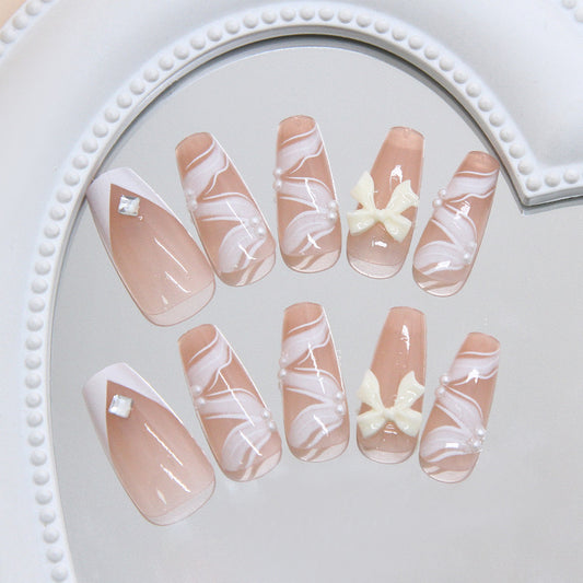 Charming Elegance Long Coffin Beige Press On Nail Set with White Swirl Design and Bow Accents