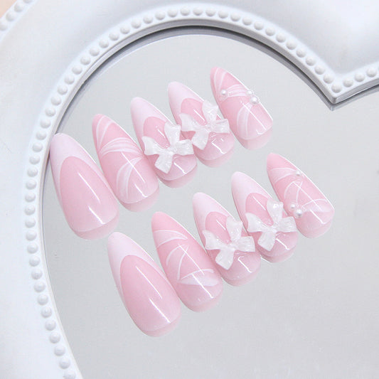 Whimsical Elegance Long Almond Pink Nails with Stunning Bow and Pearl Accents