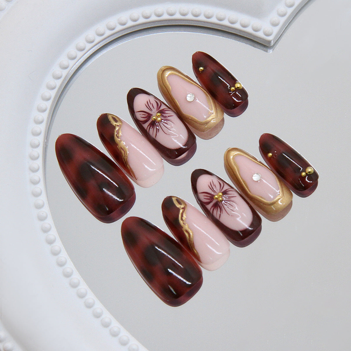 Elegant Floral Charm Press On Nail Set with Long Almond Burgundy and Pink Design Featuring Gold Accents and Intricate Floral Artwork