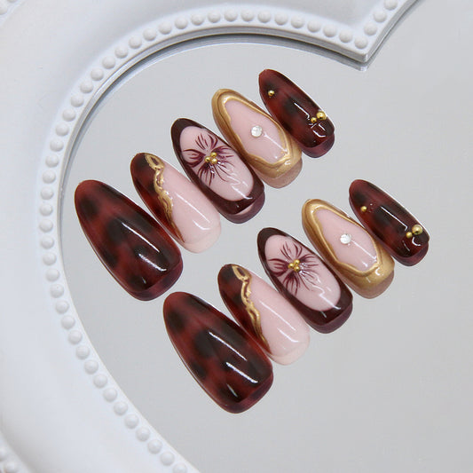 Elegant Floral Charm Press On Nail Set with Long Almond Burgundy and Pink Design Featuring Gold Accents and Intricate Floral Artwork
