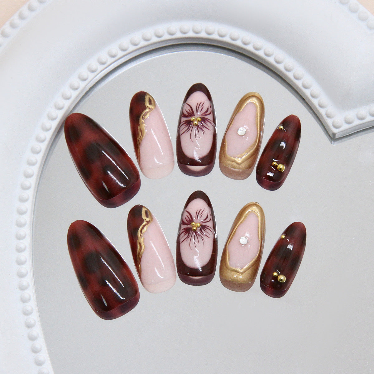 Elegance in Burgundy Elegant Long Almond-Length Press-On Nail Set with Floral Accents and Gold Detailing