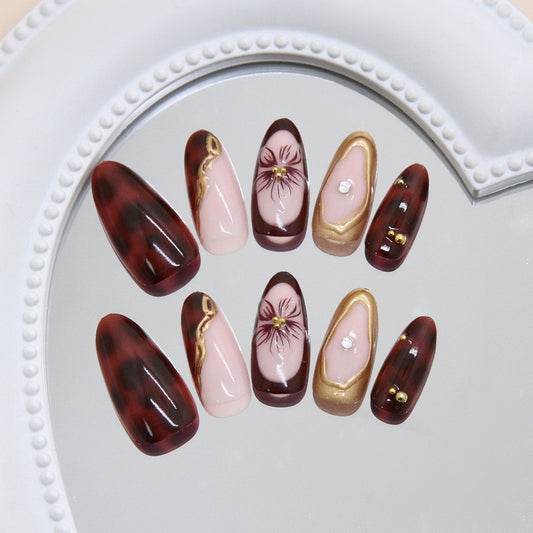 Elegance in Burgundy Elegant Long Almond-Length Press-On Nail Set with Floral Accents and Gold Detailing