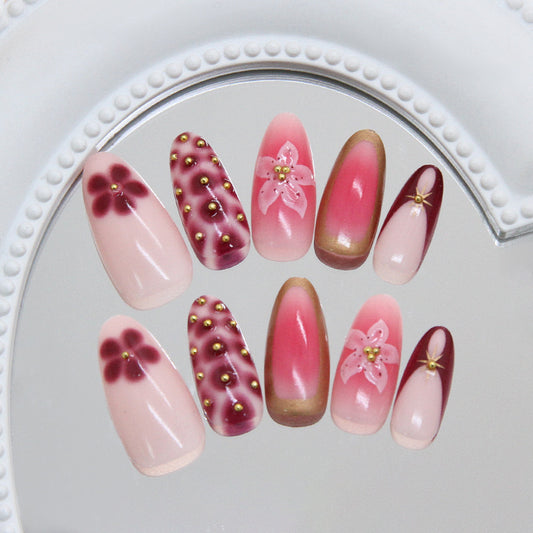 Blooming Elegance Long Almond Gradients in Soft Pink and Rich Burgundy with Floral Accents and Gold Studs