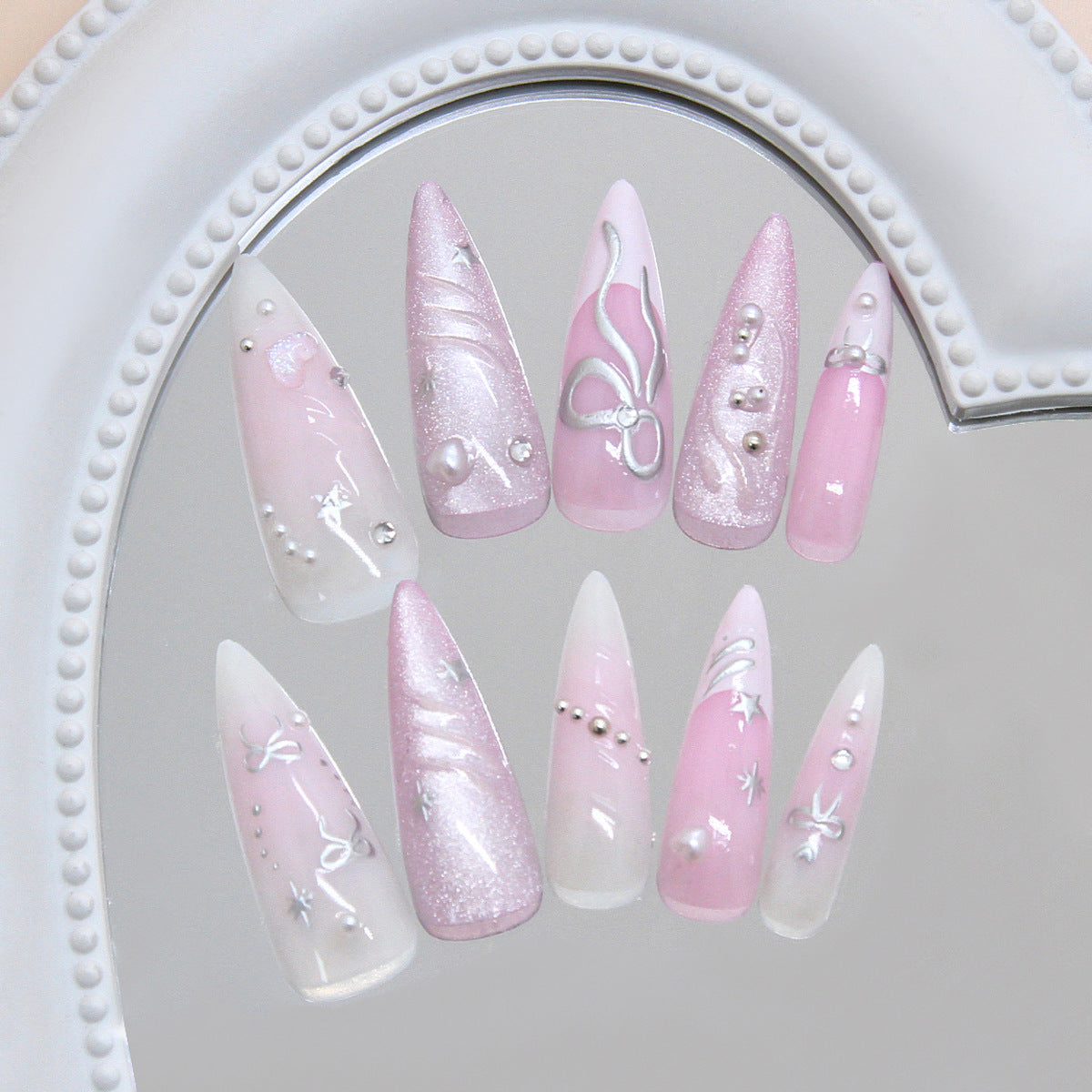 Whimsical Pink Elegance Long Stiletto Shaped Glossy Pink Press On Nail Set with Glittering Accents and Intricate Designs