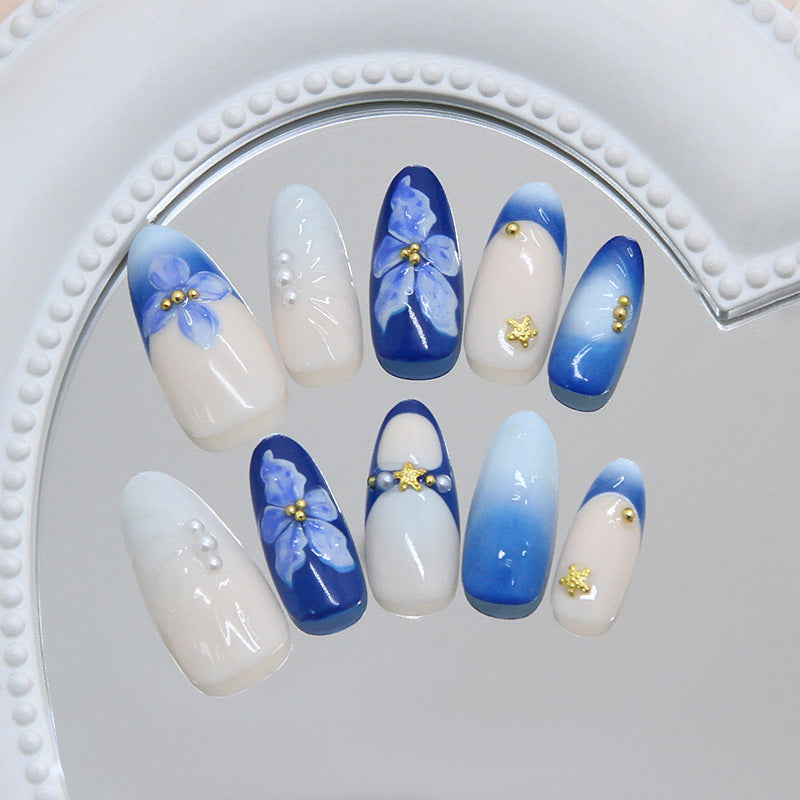 Whimsical Ocean Breeze Long Almond Blue Gradient Nail Set with Floral Accents and Gold Stars