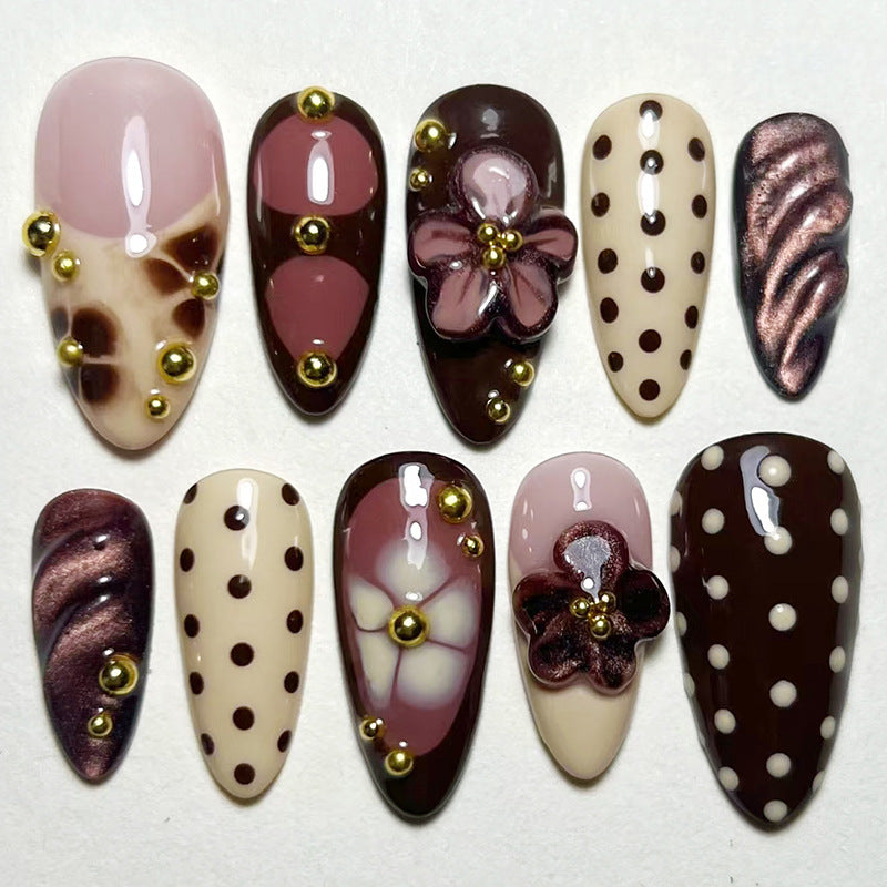 Chic Dessert Inspired Long Almond Shape Brown and Pink Nails with Unique Floral and Polka Dot Embellishments