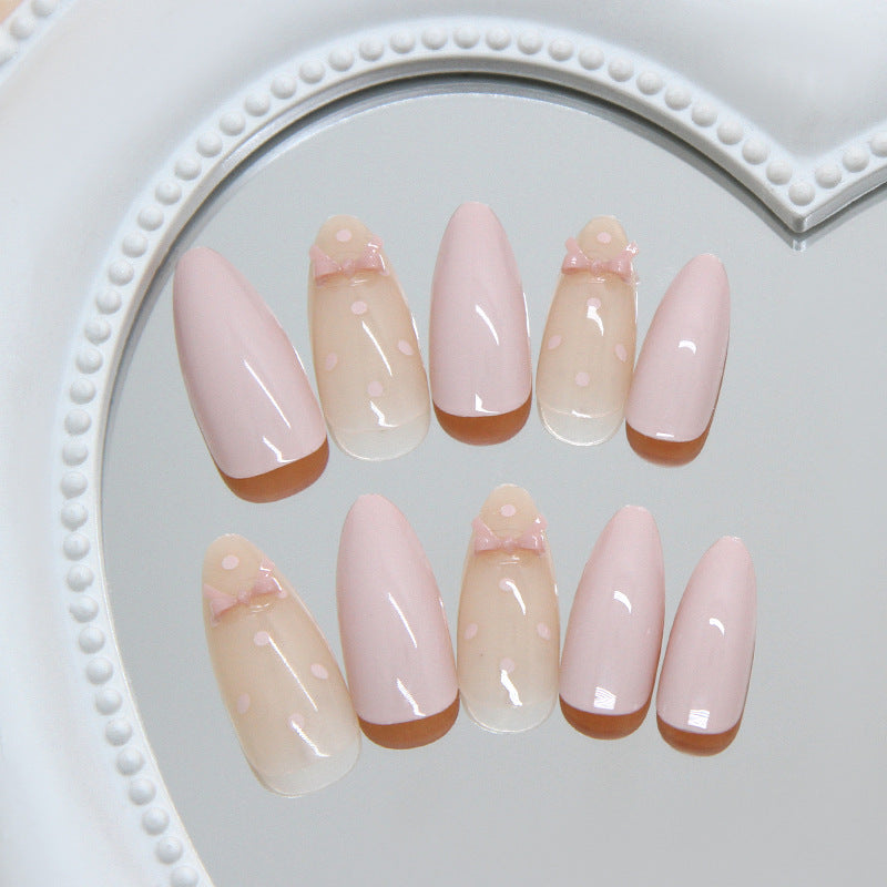 Delicate Charm Medium Almond Pink Nails with Sweet Bow Accent