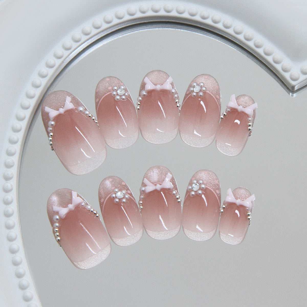 Charming Elegance Short Round Pink Ombre Nails with Bow and Pearl Accents