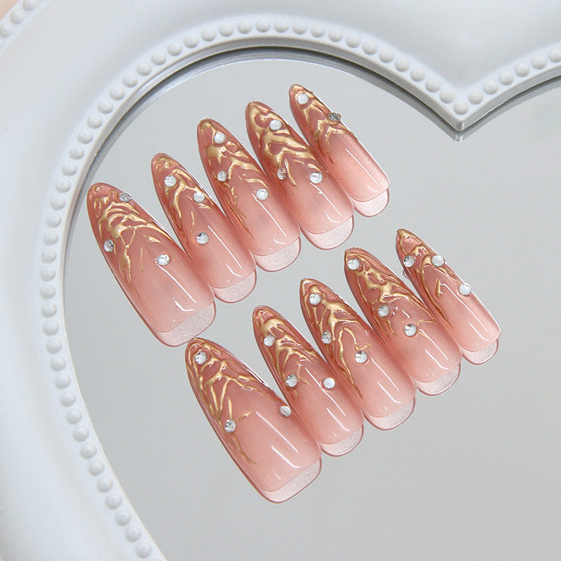 Glamorous Elegance Medium Almond Blush Pink Nails with Metallic Swirls and Rhinestone Accents