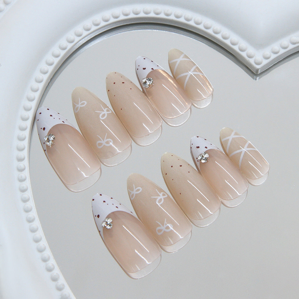 Chic Elegance Medium Almond Beige Nails with Unique White Accent Design