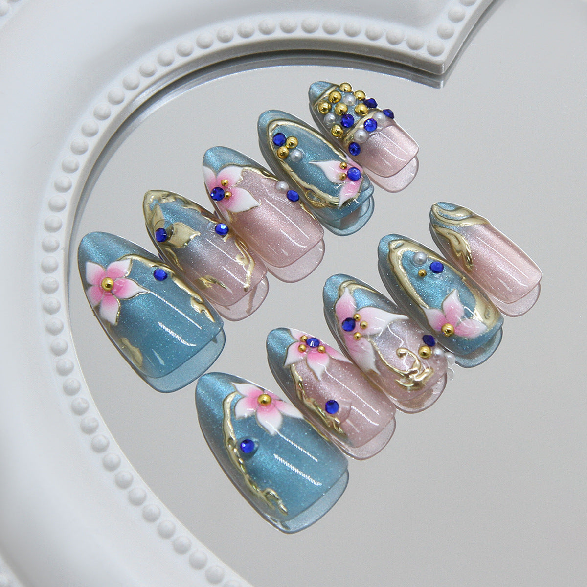 Elegant Blossom Medium Almond Blue with Floral Accents and Gemstone Embellishments