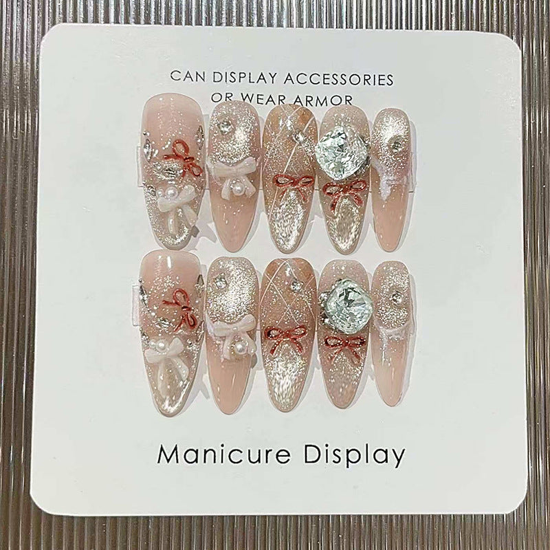 Enchanting Elegance Long Almond Blush Nails with Decorative Gems and Ribbons
