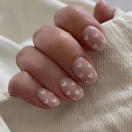 Romantic Affair Short Oval Beige Press On Nails with White Heart Accents