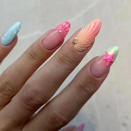 A set of press-on nails featuring a variety of pastel colors and decorated with starfish and shell designs.