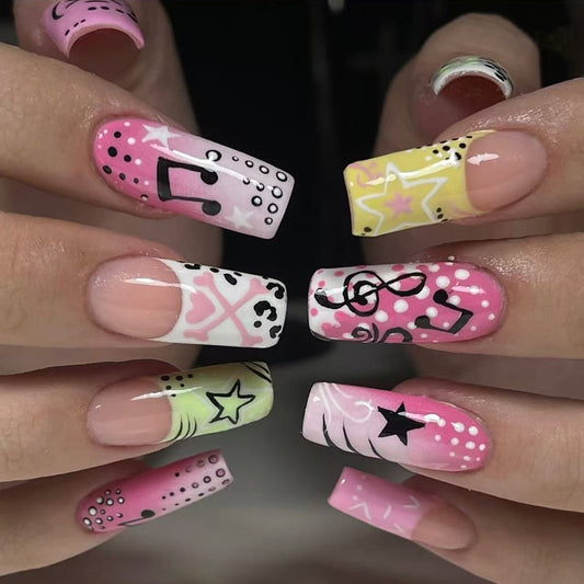 Nails with colorful designs including stars, music notes, and polka dots.