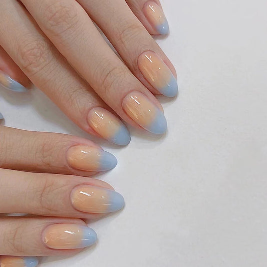 Close-up of hands with gradient nail polish on a plain background
