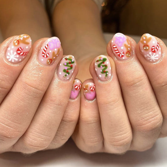 A set of beige false nails with Christmas candy and snowflake designs