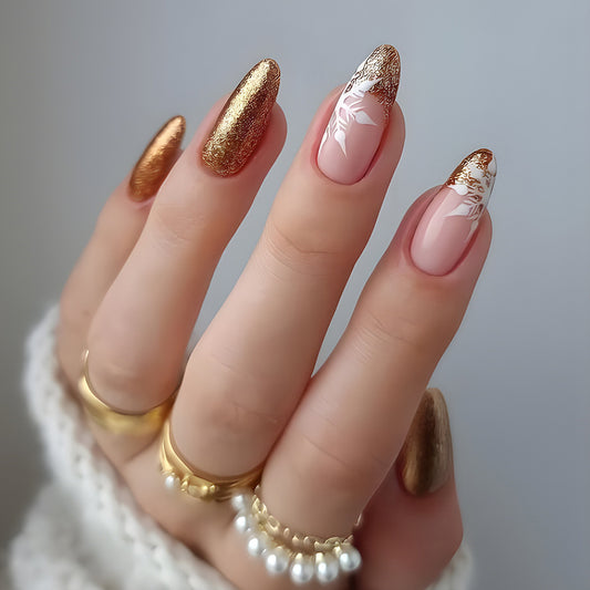 Close-up of a hand with pink and gold nails against a neutral background