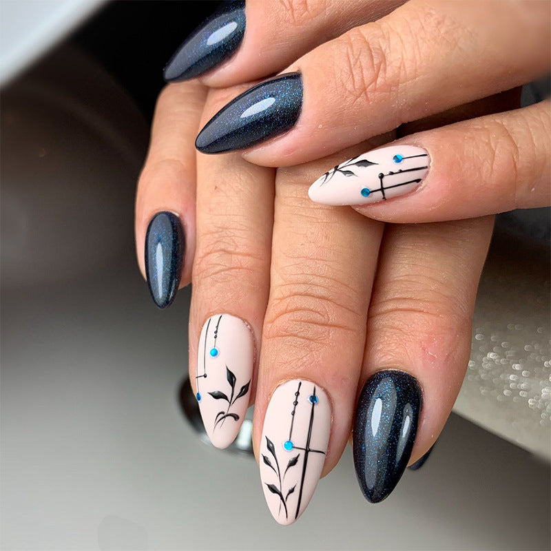 Enchanted Evening Medium Almond Black and White Press On Nail Set with Elegant Botanical Accents and Blue Rhinestone Detail