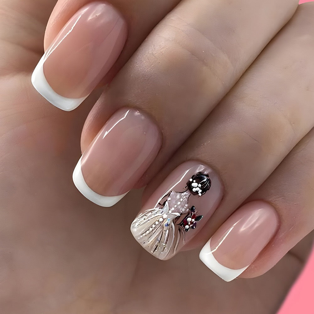 A set of press-on nails featuring a design of a ballerina girl with white and silver colors, and French tips.