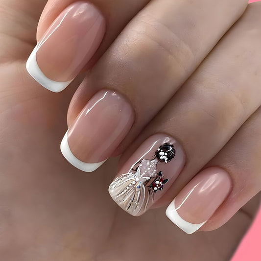 A set of press-on nails featuring a design of a ballerina girl with white and silver colors, and French tips.