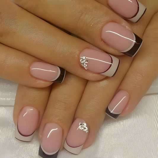 A set of press-on nails featuring a medium square shape with a black French tip design, mounted on a hand.