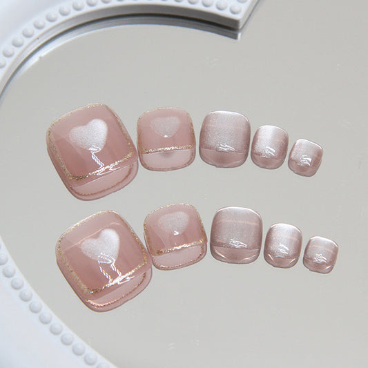 Set of pink nail art designs on a white heart-shaped stand