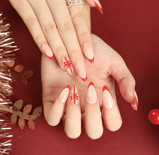 Close-up of hands with red and white nail design on a red background