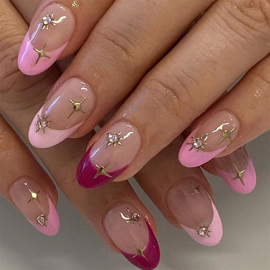 A set of press-on nails featuring a medium oval shape with a pink French tip design, adorned with star decorations.