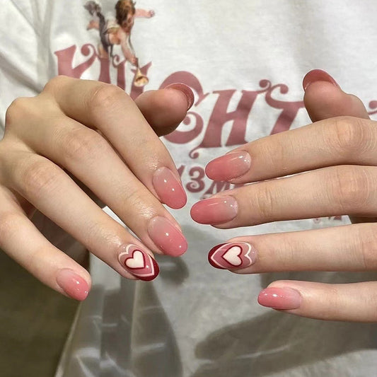 Sweetheart Medium Oval Pink Press-On Nails with Heart Accents and Ombre Design