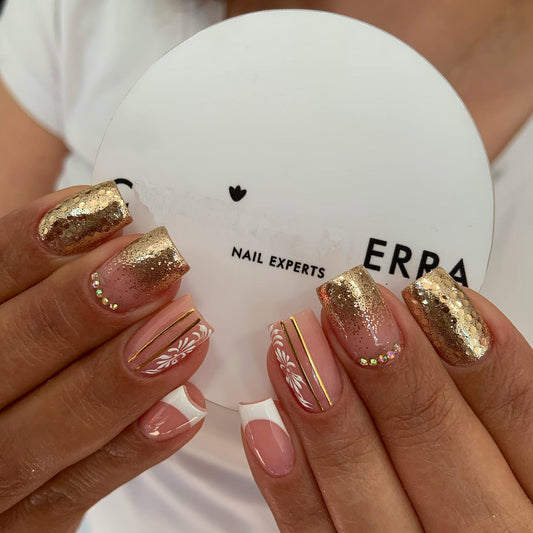 Close-up of hands with decorative nails holding a white compact mirror with 'ERBA' branding.