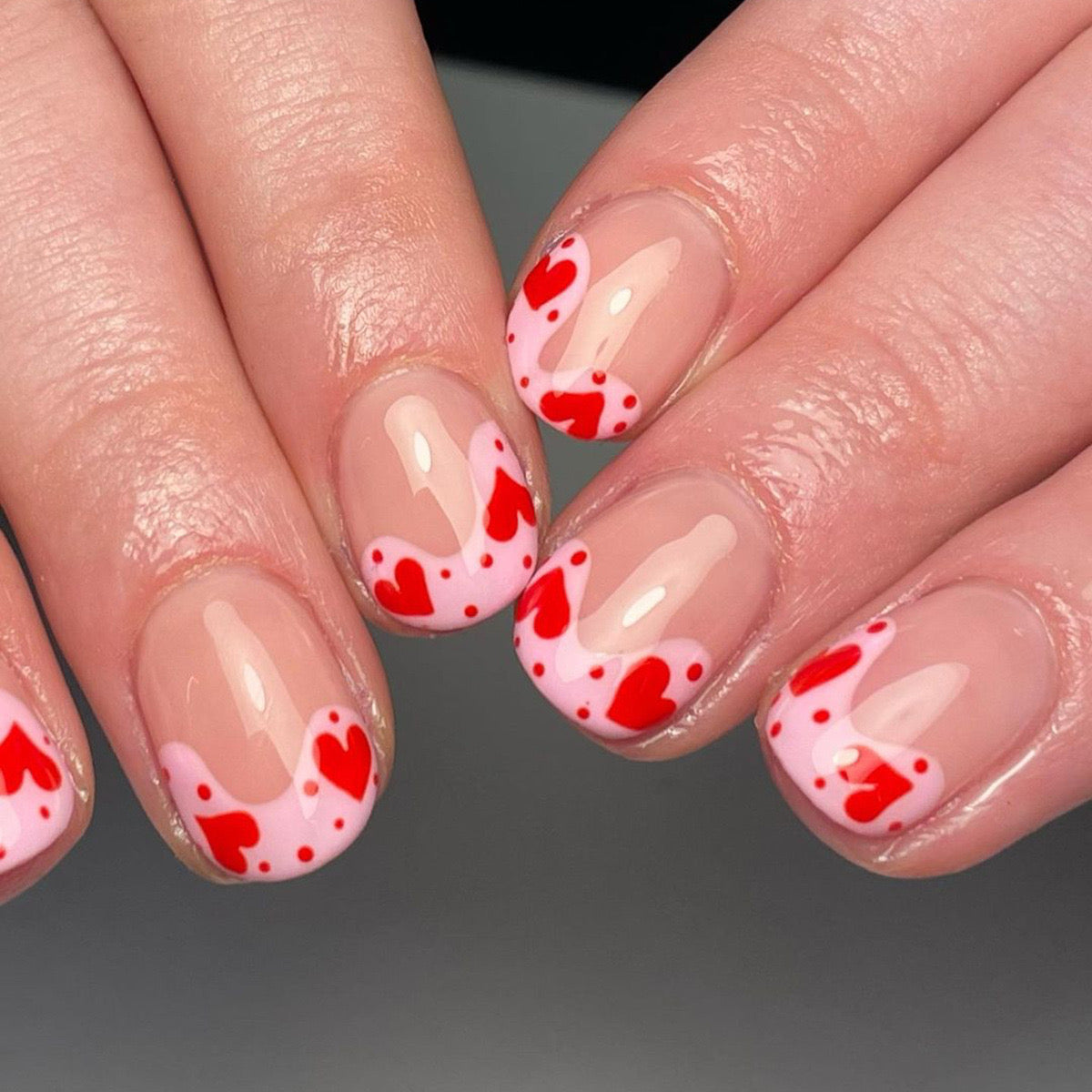Sweetheart Short Oval Natural Pink Press-On Nails with Red Heart Sprinkles for a Playful Charm