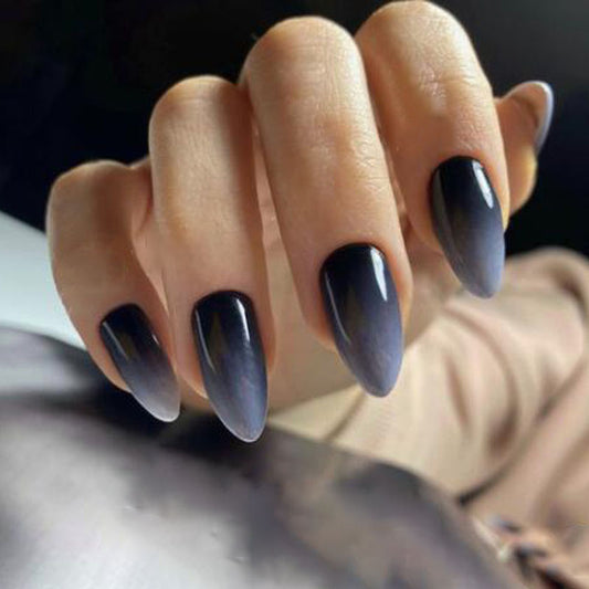 A set of long almond charcoal gradient press-on nails with an ombre effect.