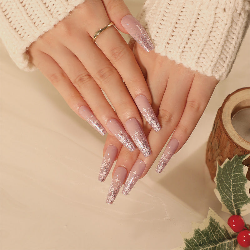 Close-up of a hand with glittery pink nails on a beige background