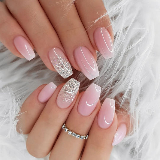 Close-up of hands with pink and white nail polish on a fluffy white background