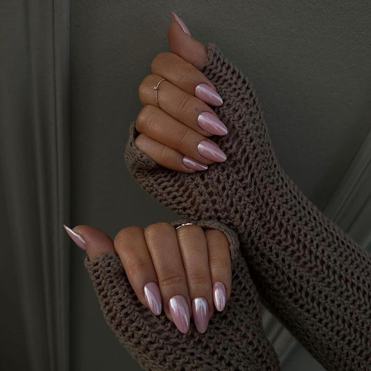 Brown fingerless gloves worn by a person with pink nail polish on a dark background