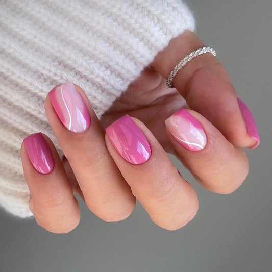 Hand with pink nail polish wearing a white textured garment