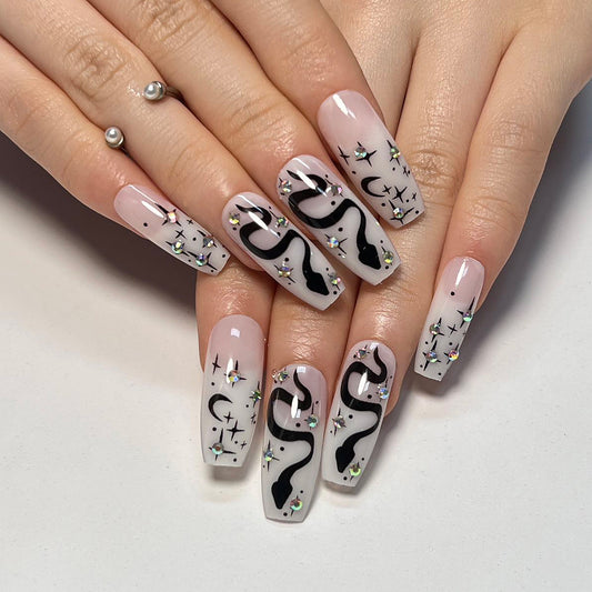 Midnight Magic Long Coffin Milky Pink Press-On Nails with Enchanting Black Swirls and Celestial Embellishments