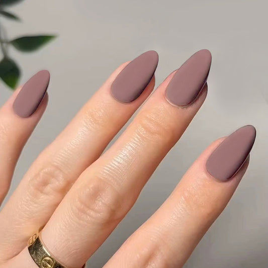 A set of medium-length almond-colored press-on nails with a matte finish.