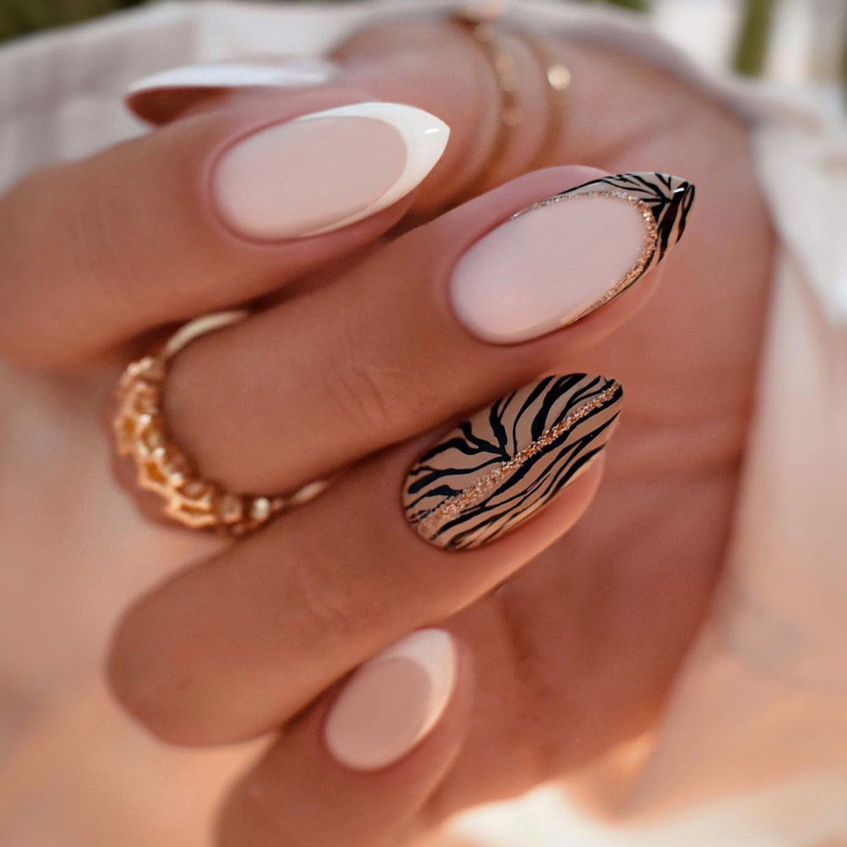 Safari Elegance Long Stiletto Soft Pink Press-On Nails with Zebra Print Accent and Gold Glitter Detailing