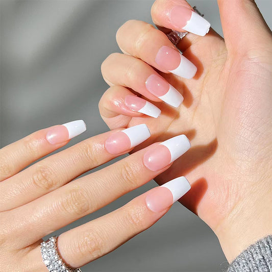 A pair of long square white French tips press-on nails being worn by a person.