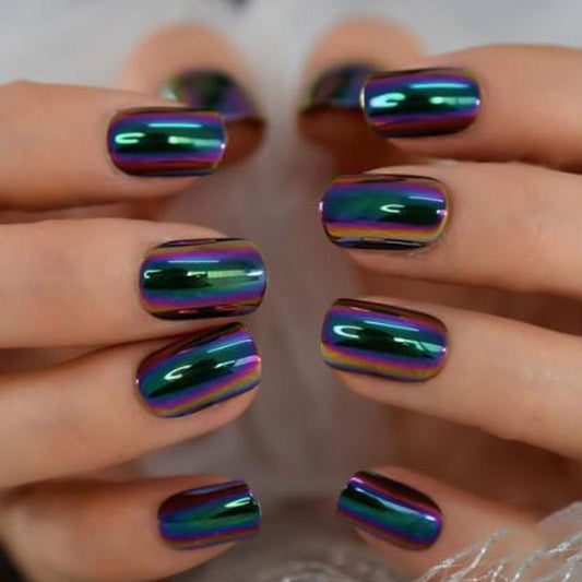 Close-up of hands with multicolored, reflective nail polish on a blurred background